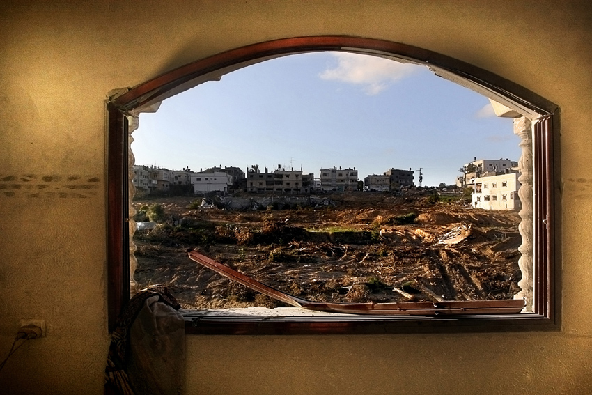 Omar Al Kanya and his father look around their destroyed house and find a lot of Israeli ammunition in Atatra, Gaza Strip on Sunday, January 18, 2009. The heaviest machine gun fire and most casualties in the three weeks of Gaza/Israel conflict were in western Beit Lahiya Atatra district, as Israeli forces sought to secure control of the northwest corner of Gaza Strip. This area includes the ruins of three former Jewish settlements abandoned in August 2008, and the Atatra district of Beit Lahiya. Atatra was isolated from the rest of the Gaza, and became a occupied by the Israeli army. During the beginning of the war, Israelis gathered all the men of the settlement and interrogated them about the location of Hamas’s center of operations. Women and children were sent to Jabaliya to find shelter. When the men and women returned to their homes after the declared cease-fire, they found their homes vandalized and destroyed.